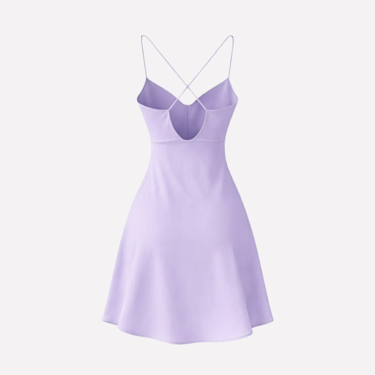 Flat lay product shot of the back of the Kouvr light purple slip dress, detailing the criss-cross straps on a white background.