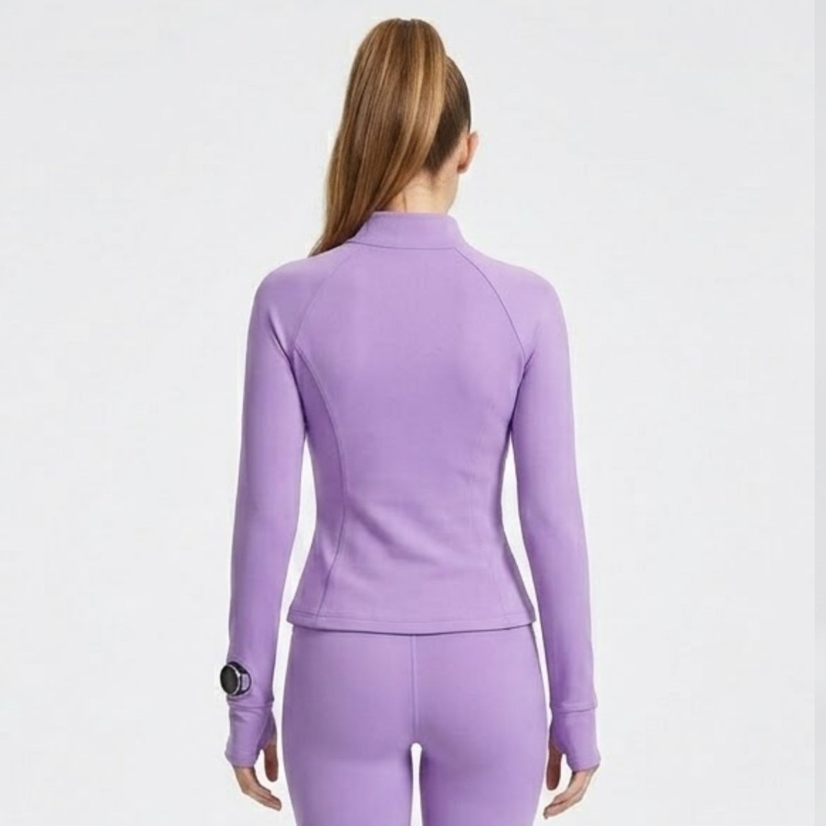 Back view of women's luxury light purple athletic zip-up jacket showing tailored contour seam details.