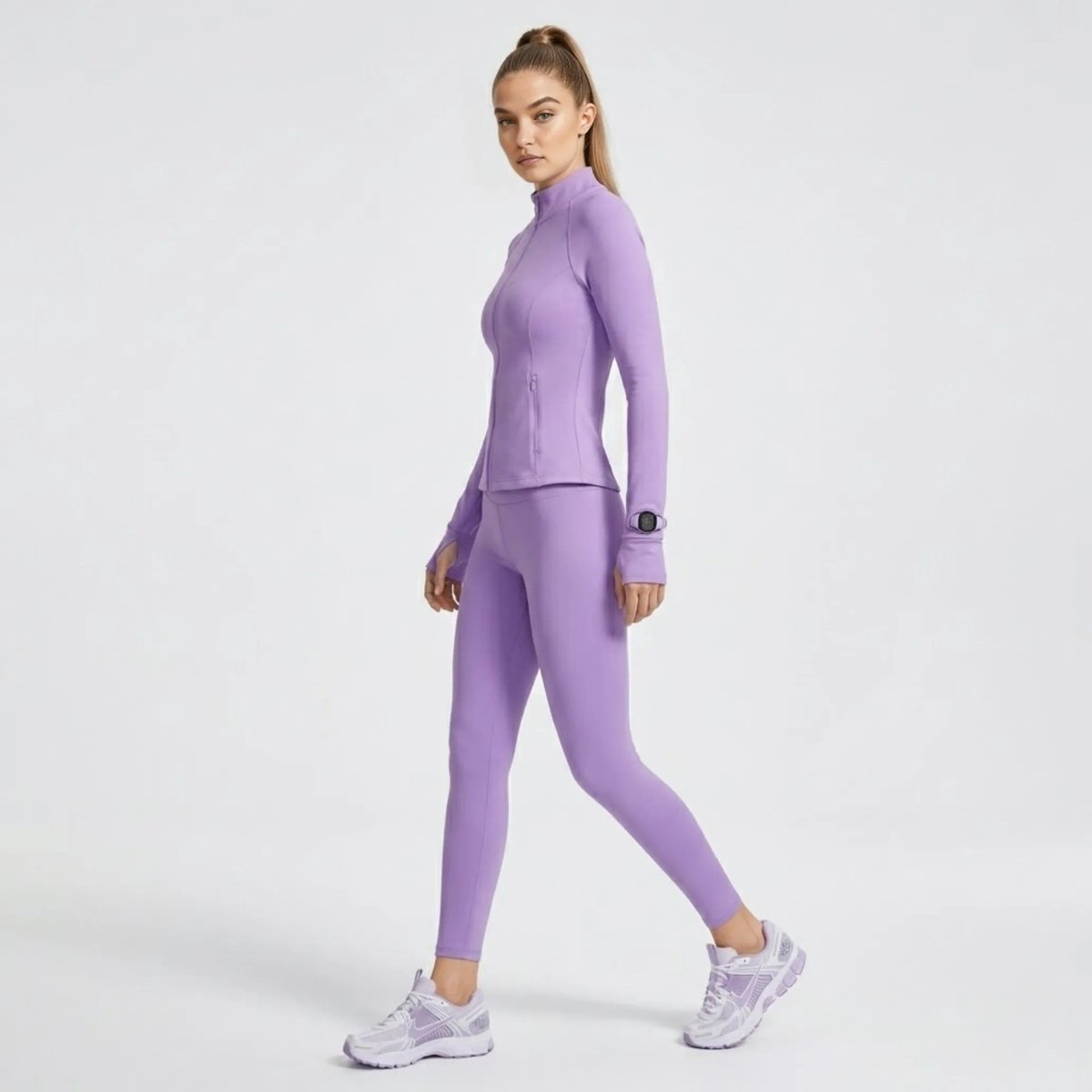 Side profile of model in fitted light purple workout jacket highlighting the innovative sleeve watch window.