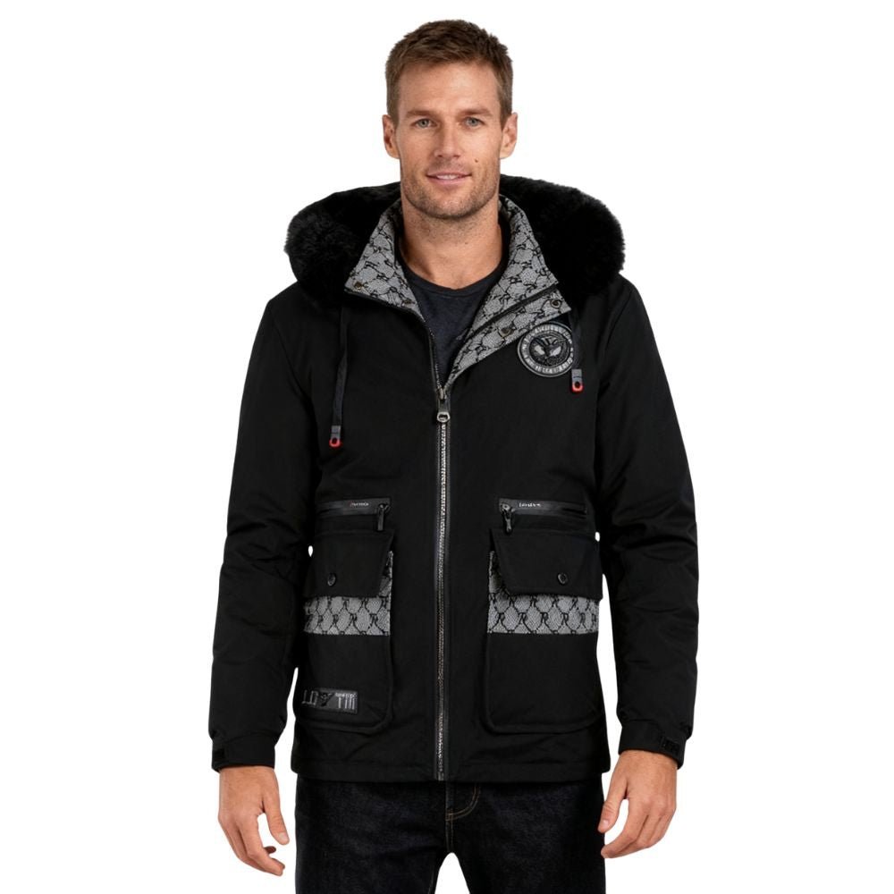 Man wearing a black kouvr jacket with fur-lined hood on a white background