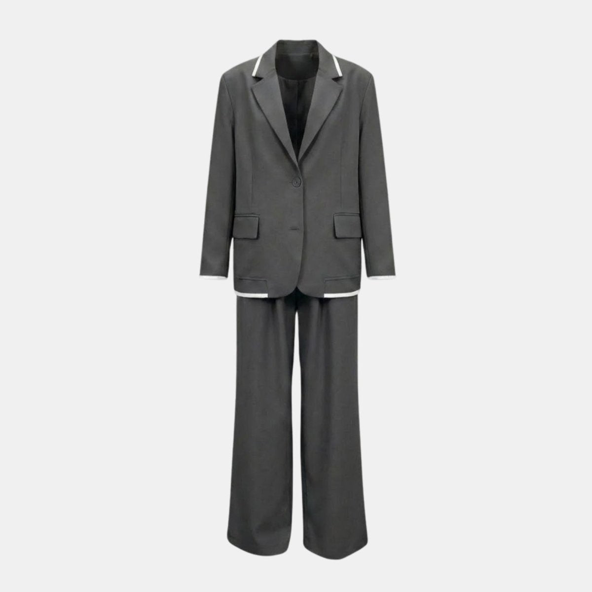 Flatlay product shot of the Kouvr Lucia Set two-piece suit in dark grey, displaying the front of the single-button blazer and wide-leg trousers, highlighting the white contrast piping.