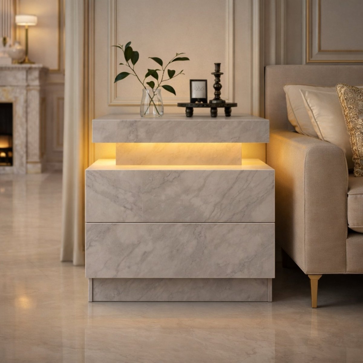 The Kouvr Lumina modern white nightstand with two drawers, illuminated with cool blue LED light, placed next to a contemporary upholstered bed.