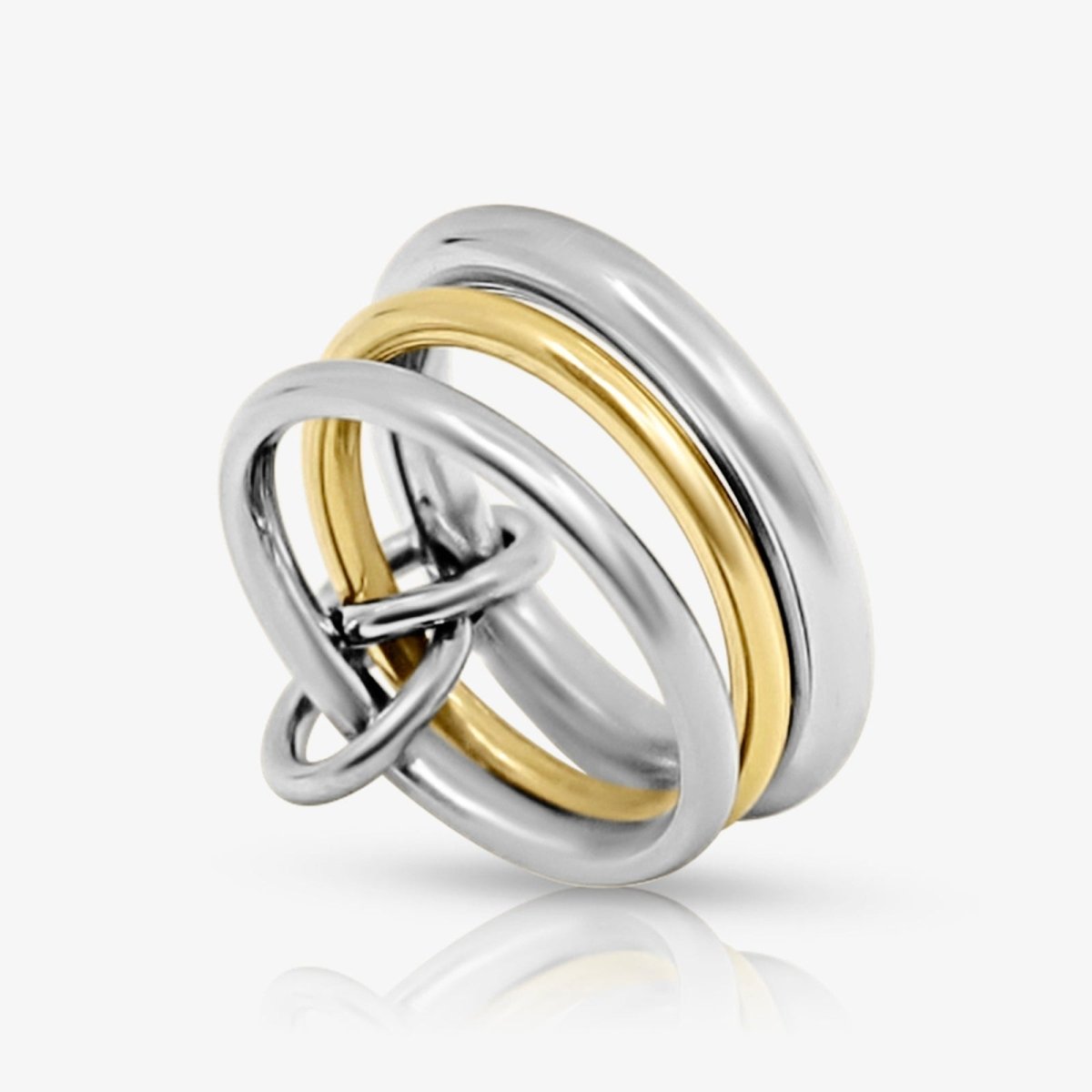 Studio product shot of the Kouvr Mavis two-tone rolling ring with two sterling silver bands and one gold band.