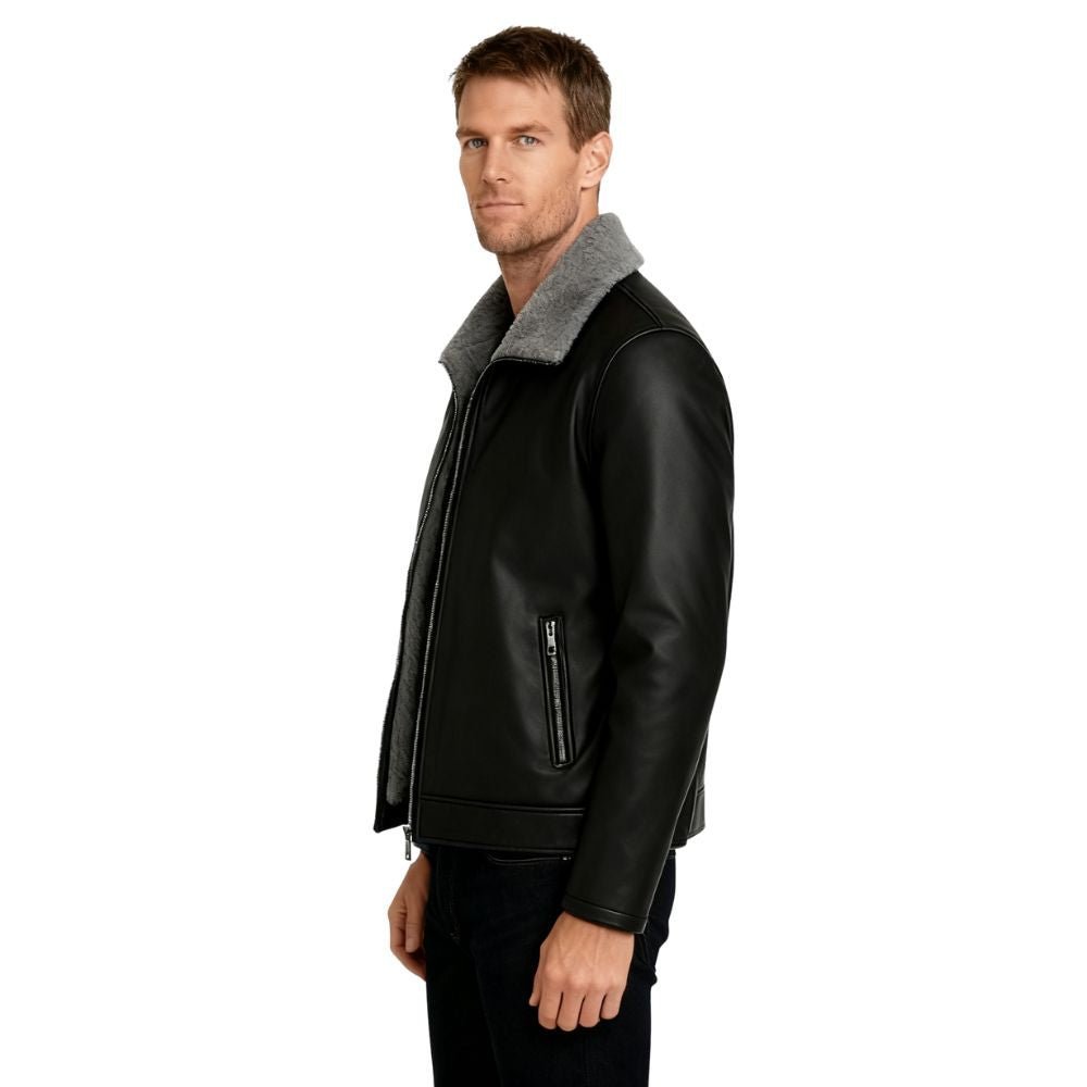 Man wearing a black kouvr leather jacket with gray fur collar on a white background