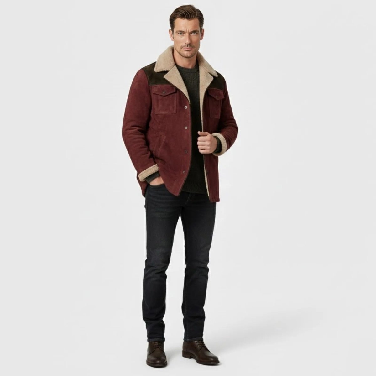 Man wearing the Kouvr Fashion burgundy suede shearling-lined trucker jacket with dark wash jeans and a dark green sweater.
