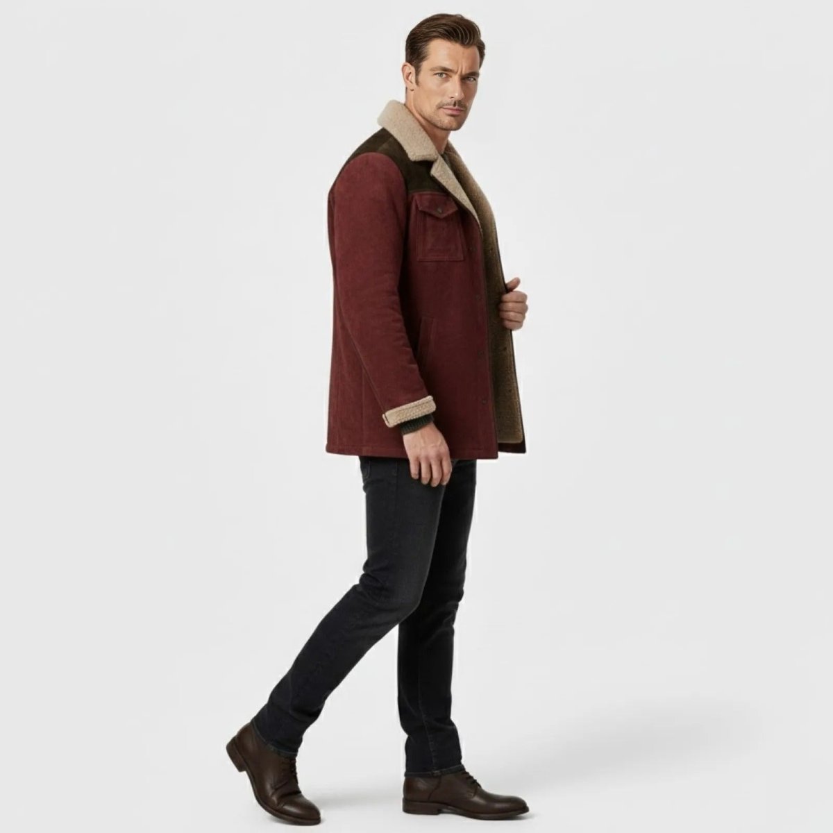 Side profile view of a man walking in the Kouvr burgundy suede jacket showing its fit and hip-length cut.
