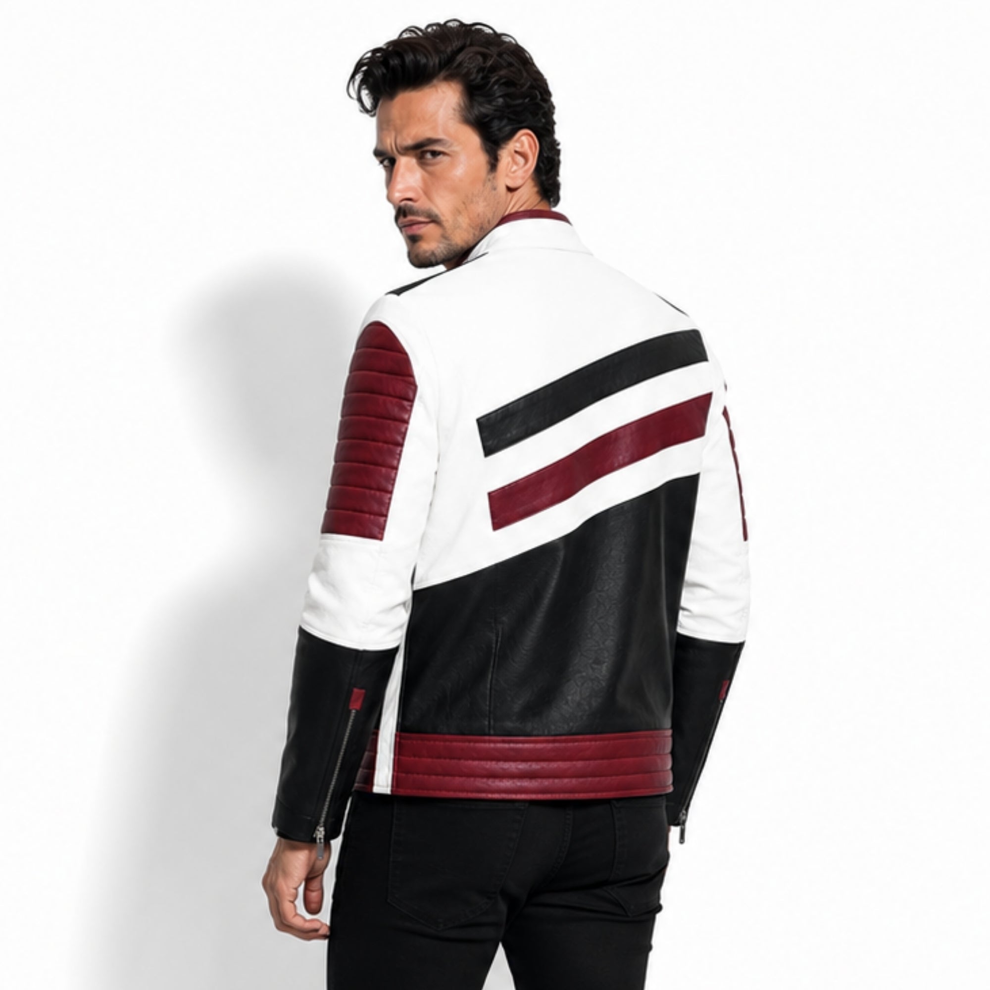 Back angle of a model wearing the Kouvr men's streetwear moto jacket detailing the striking red and black asymmetrical stripe design on a white base.