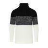 A man wearing the Kouvr color block turtleneck sweater in black, textured grey, and cream, paired with black trousers.