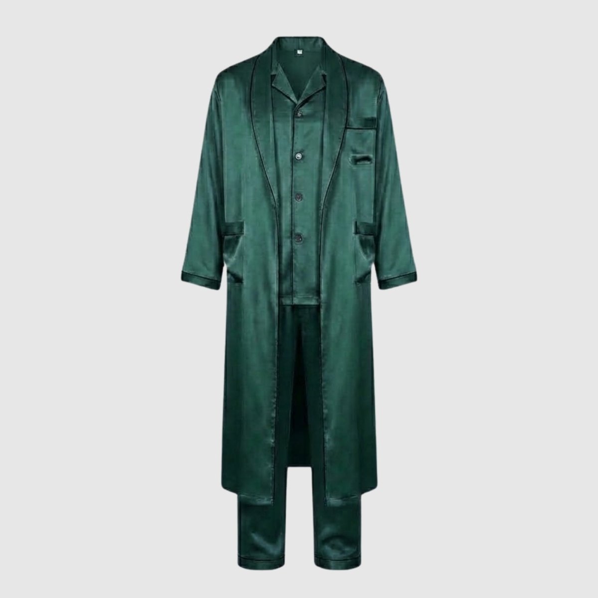 Flat lay of the Kouvr three-piece men's loungewear set in green satin, showing the pajama shirt, pants, and open robe against a light grey background.