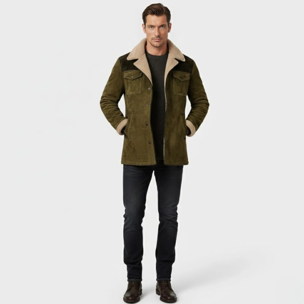 Male model wearing the Kouvr olive green suede shearling-lined field jacket with a dark sweater and black jeans.