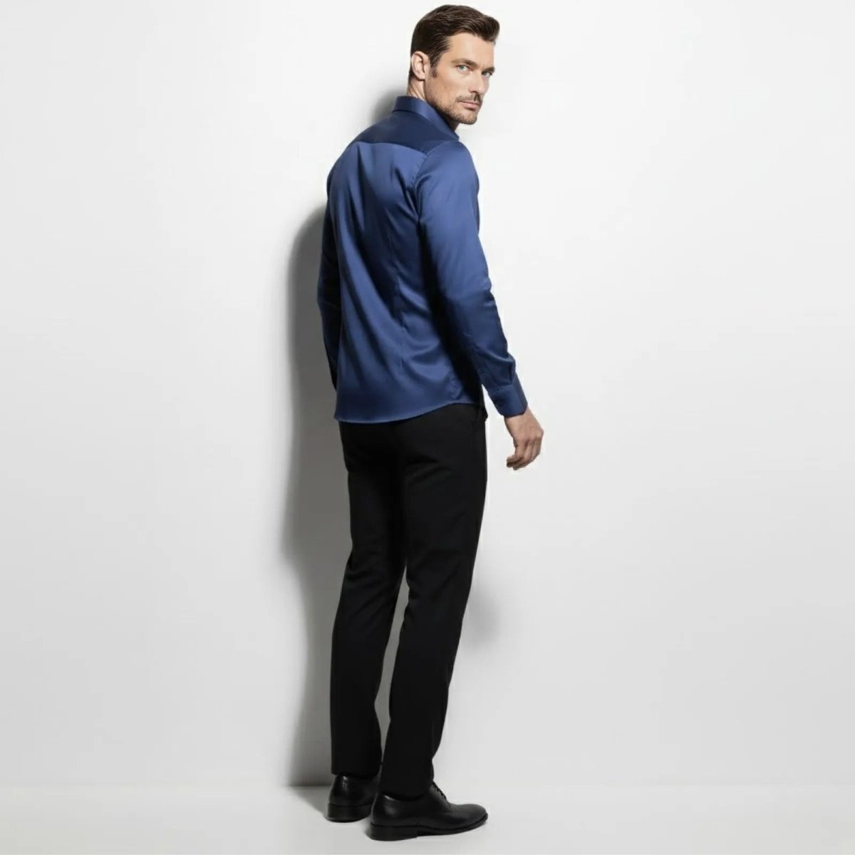 Back view of the Kouvr men's slate navy blue performance dress shirt, highlighting the structured yoke and tailored fit.