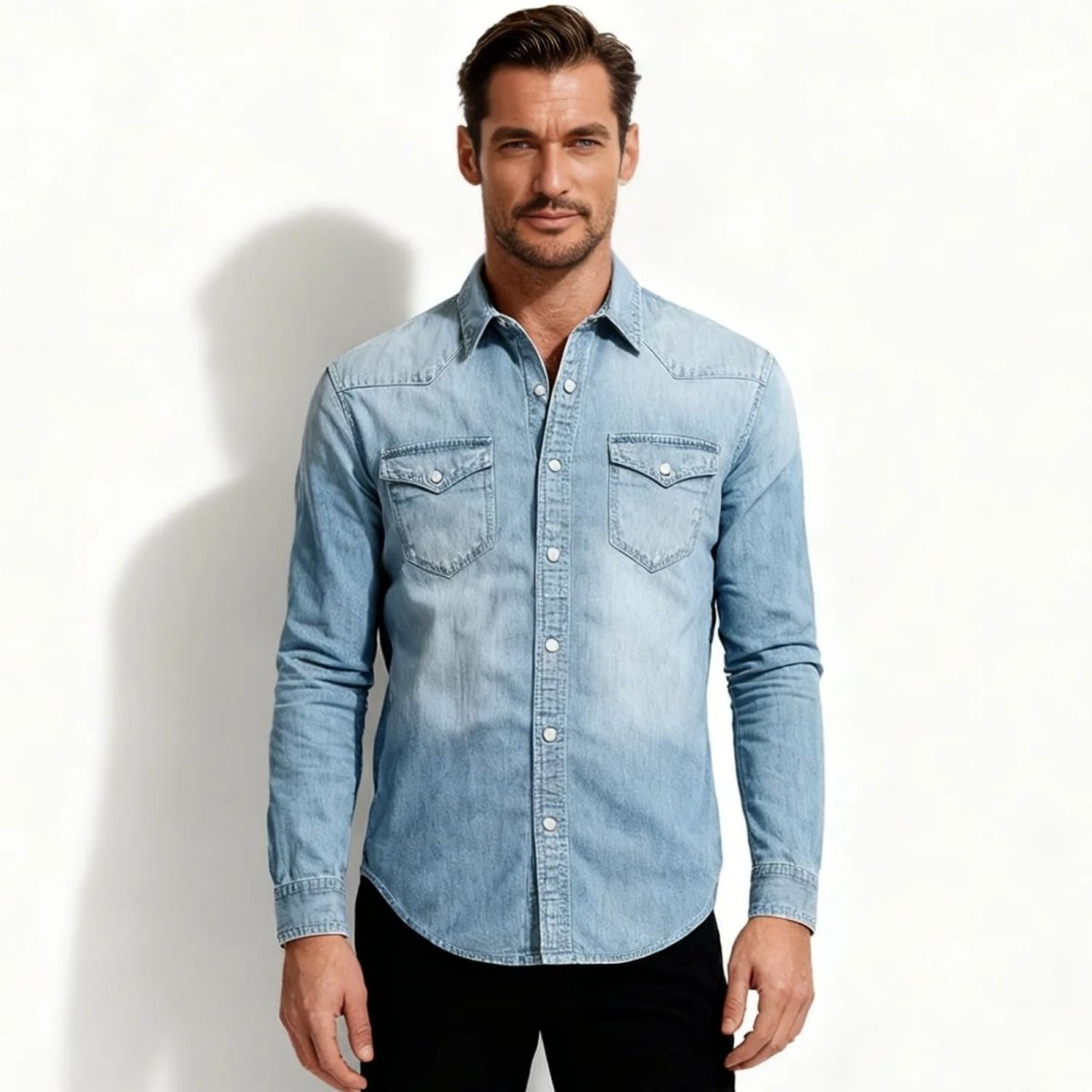 Man wearing a light blue Kouvr denim shirt against a white background
