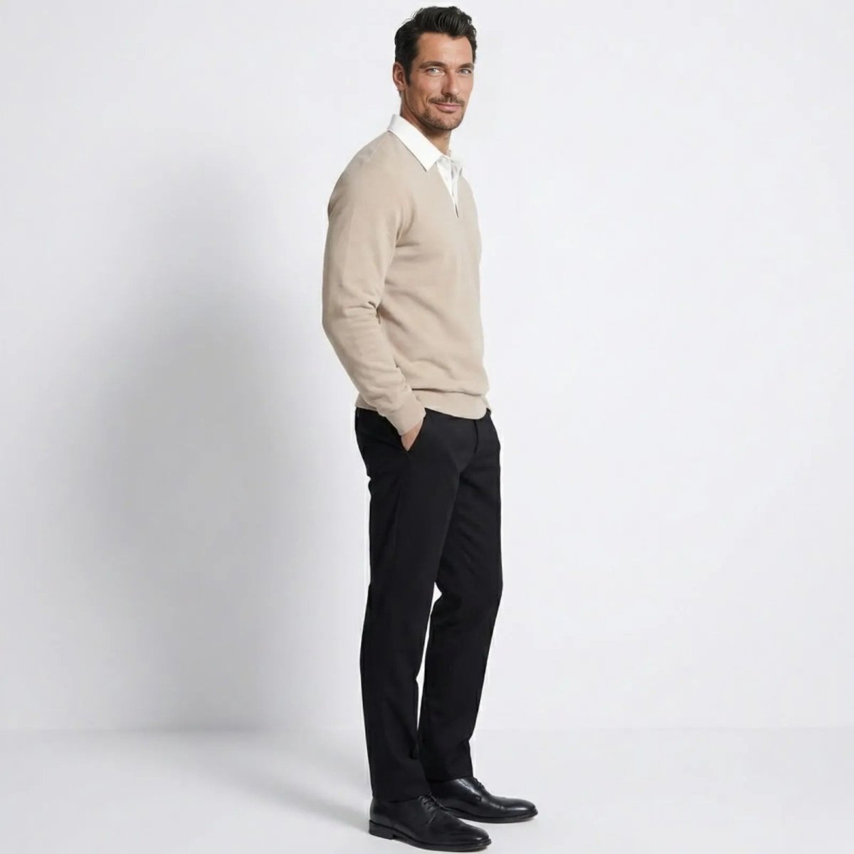 Side view of a man in the Kouvr light beige collared pullover sweater, highlighting the silhouette and sleeve length.