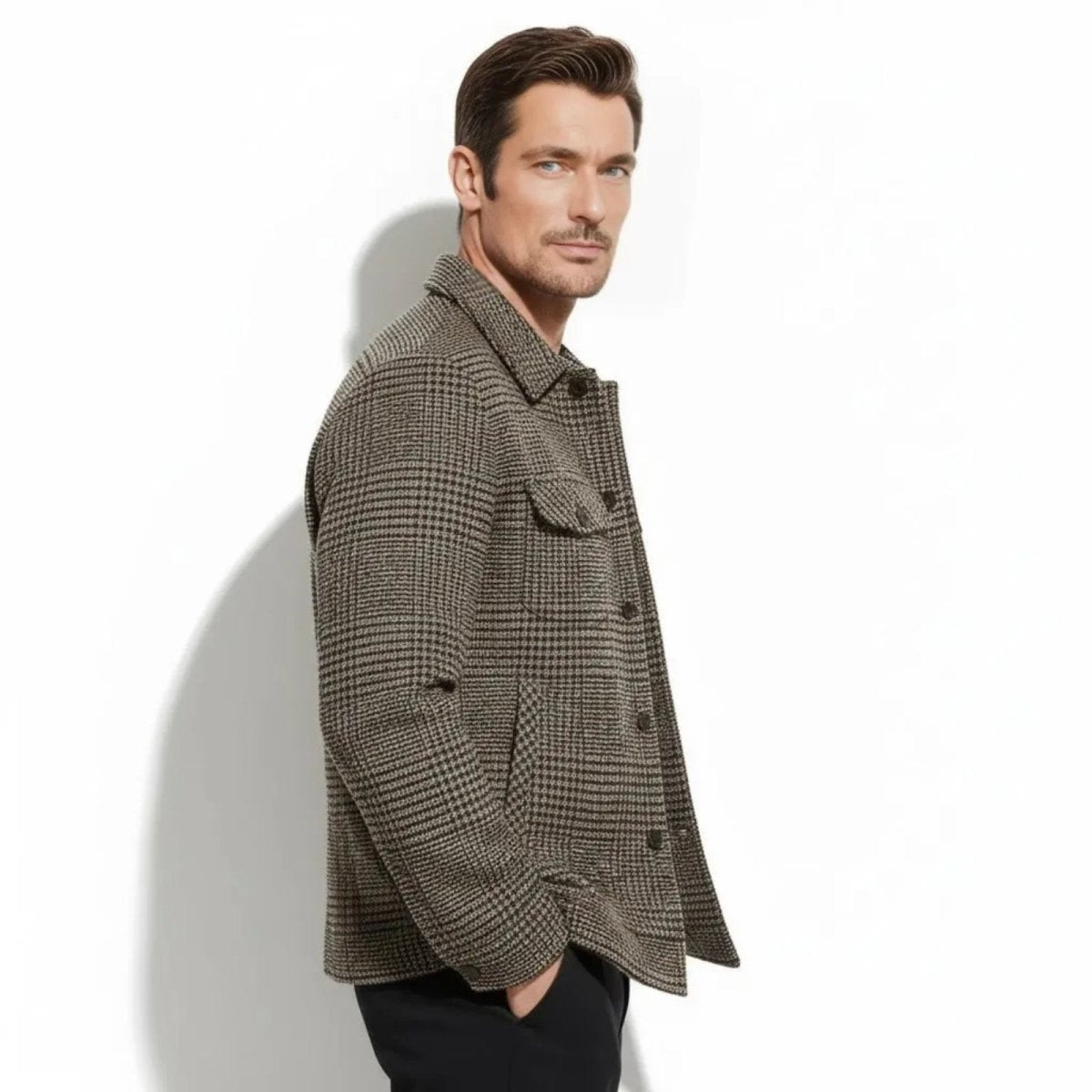 Side profile of a man wearing the Kouvr wool-blend overshirt in a brown houndstooth pattern, showing the fit and sleeve length.