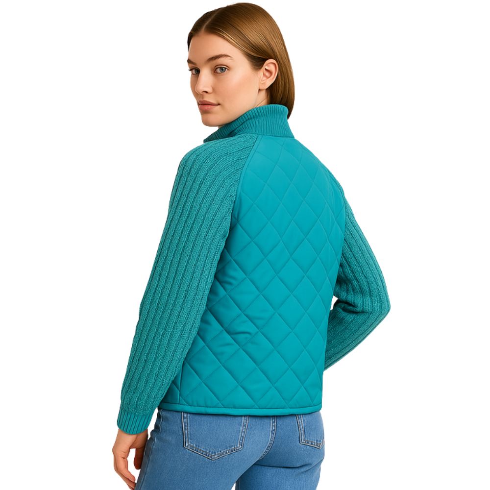 Model wearing the Kouvr Mika Hybrid Bomber Jacket in Aegean Teal, featuring cable-knit sleeves and a diamond-quilted body, paired with light-wash skinny jeans