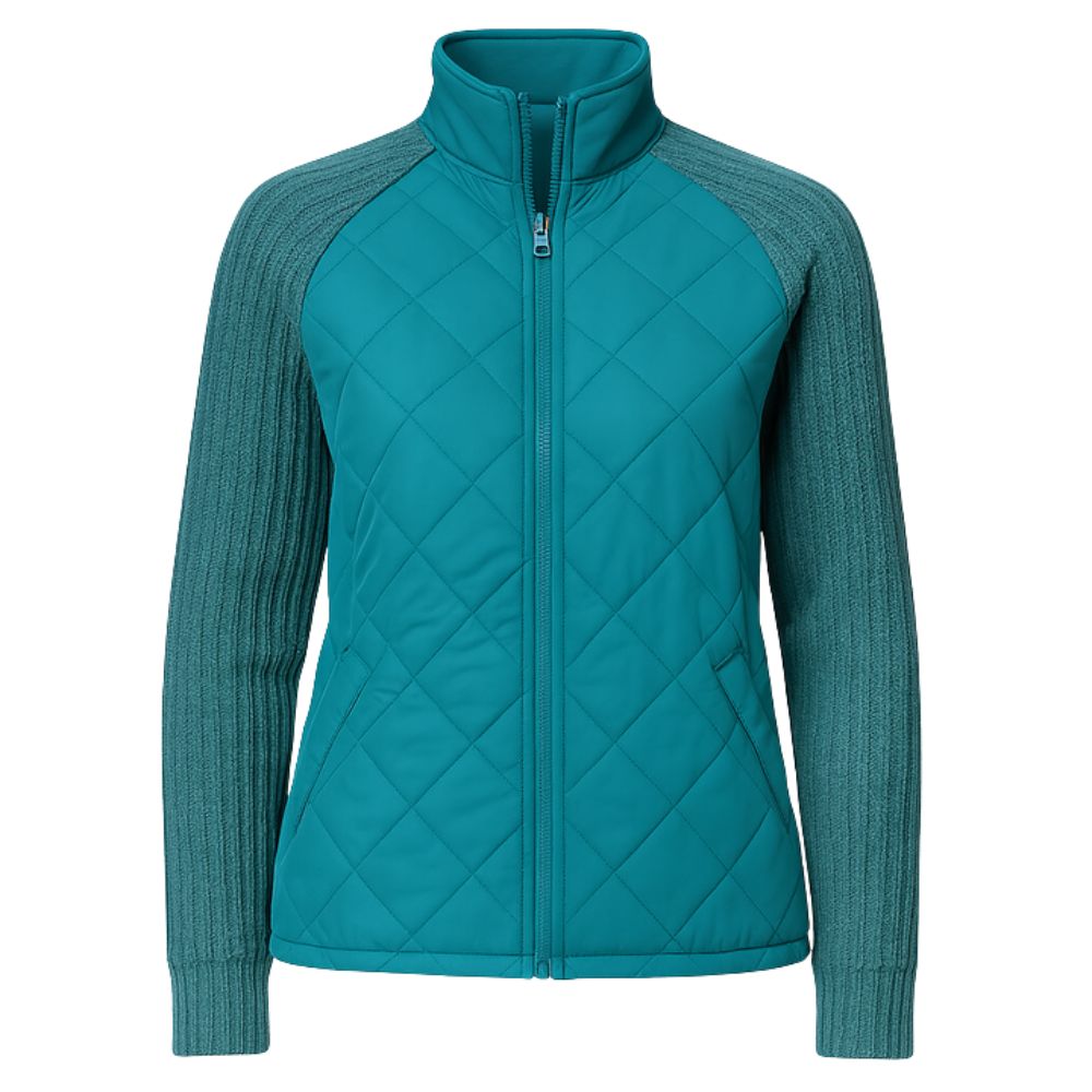 Model wearing the Kouvr Mika Hybrid Bomber Jacket in Aegean Teal, featuring cable-knit sleeves and a diamond-quilted body, paired with light-wash skinny jeans