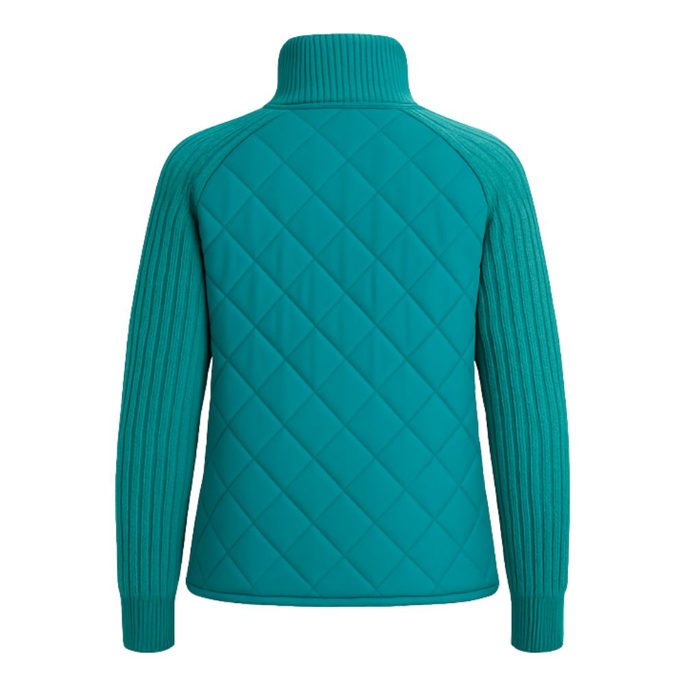 Model wearing the Kouvr Mika Hybrid Bomber Jacket in Aegean Teal, featuring cable-knit sleeves and a diamond-quilted body, paired with light-wash skinny jeans