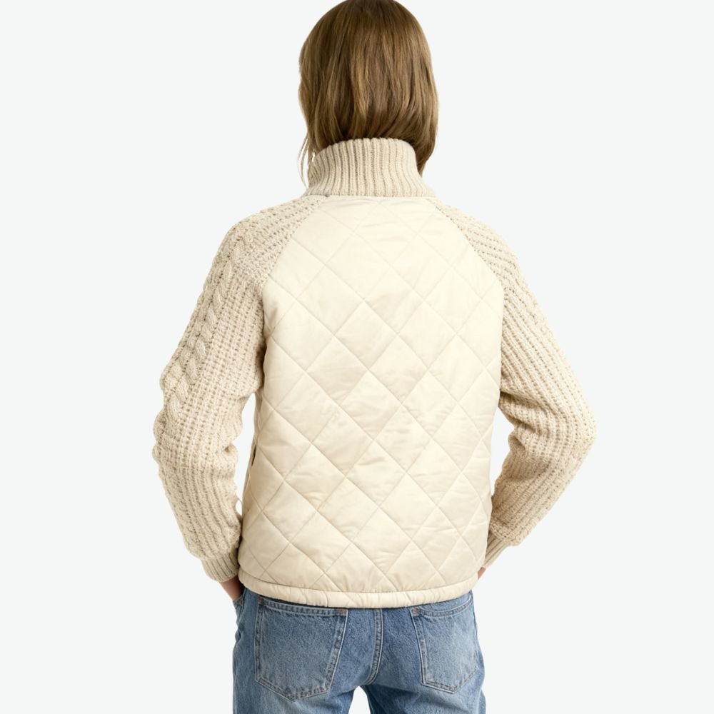 Model wearing the Kouvr Arlington Quilted Hybrid Jacket with blue jeans
