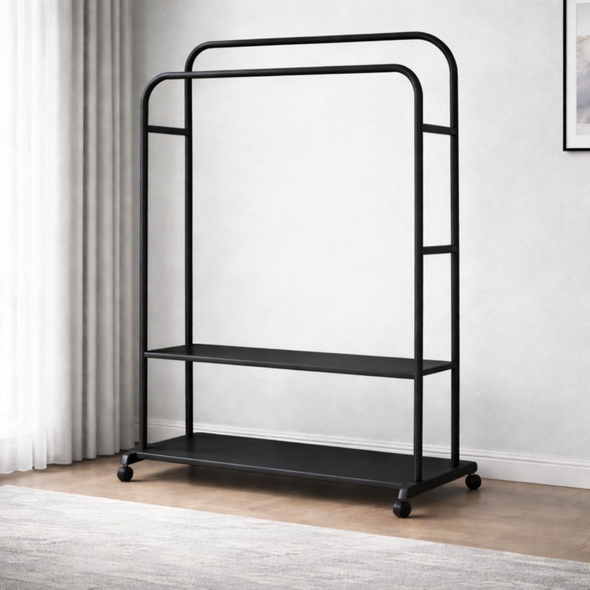 The Kouvr double rod rolling garment rack in a matte black finish, shown empty in a brightly lit, minimalist room to highlight its clean lines and two storage shelves.