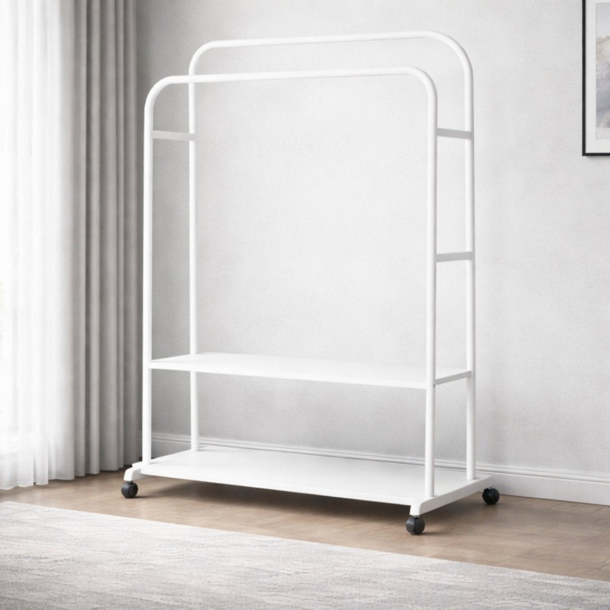 The Kouvr double rod rolling garment rack in a crisp matte white finish, shown empty to emphasize its sculptural form and spacious two-shelf design.