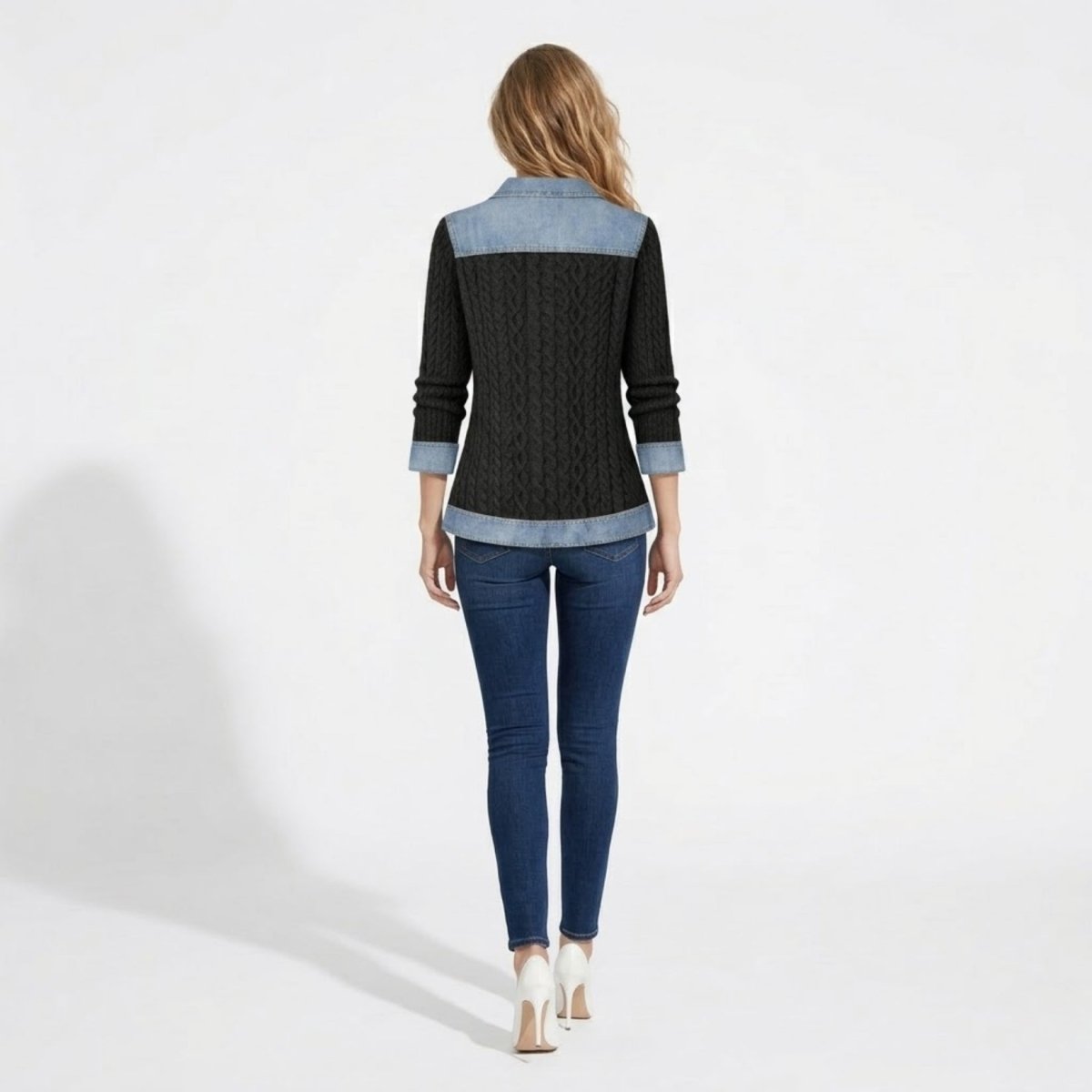Back view of the Kouvr black mixed media knit sweater showing denim shoulder yoke and hem detailing.