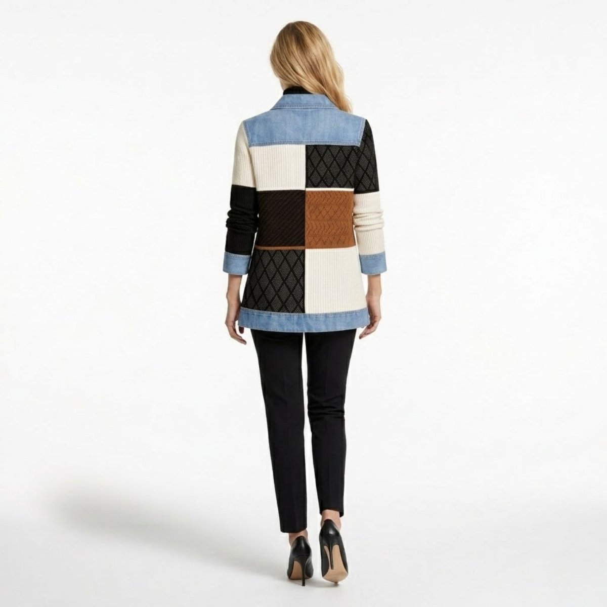 Back view of model wearing Kouvr geometric patchwork knit and denim jacket showing cream, brown, and black colorblock details.