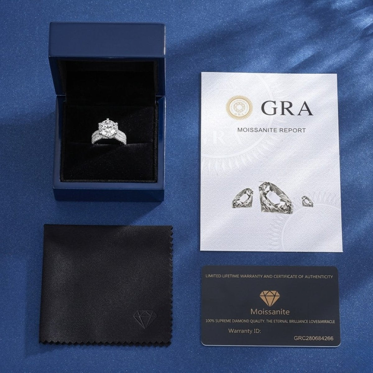 The full packaging for the Kouvr moissanite ring, including the gift box, GRA moissanite report, and certificate of authenticity and warranty card.