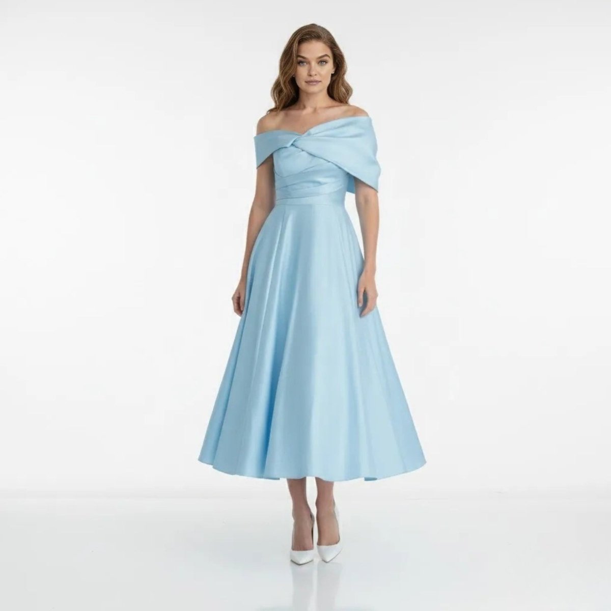 Model wearing the Kouvr Nadine light blue off-shoulder midi dress with a draped neckline and A-line skirt, front view.