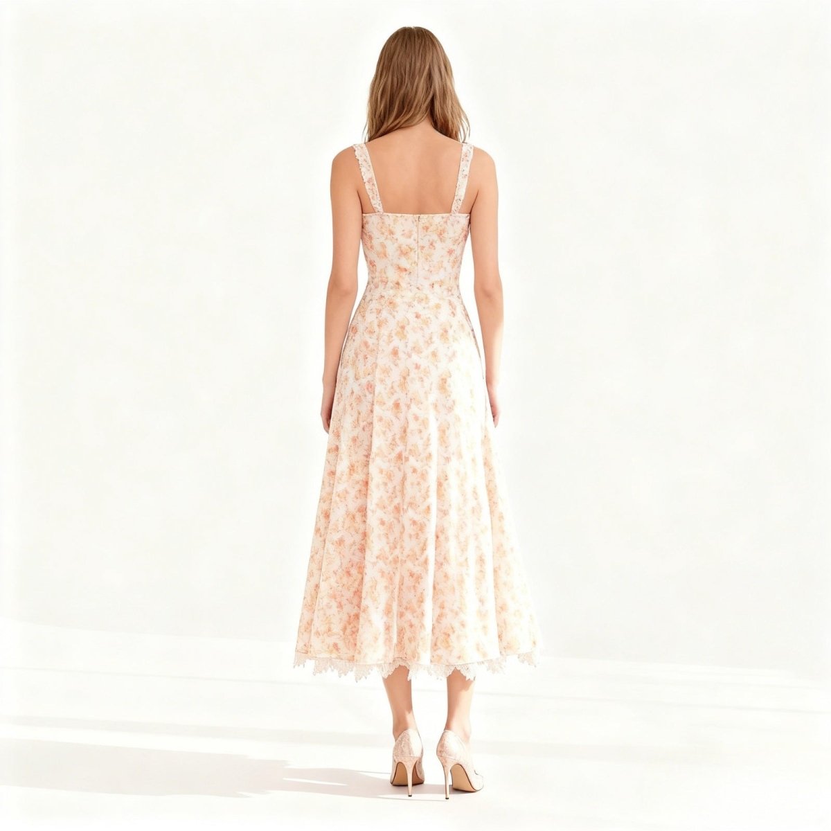 Back view of the Kouvr Fashion peach dress highlighting the smocked back panel and delicate lace shoulder.