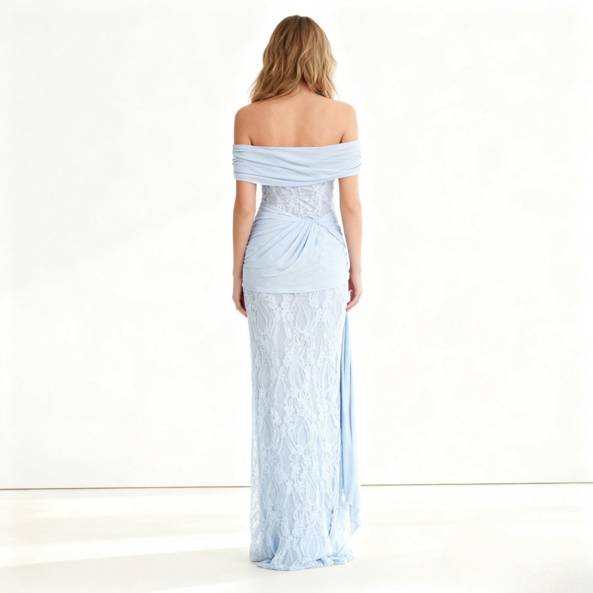 Woman wearing a light blue Kouvr off-shoulder gown on a white background
