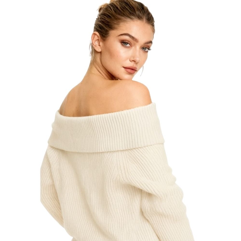 Woman wearing a kouvr cream off-shoulder sweater on a white background