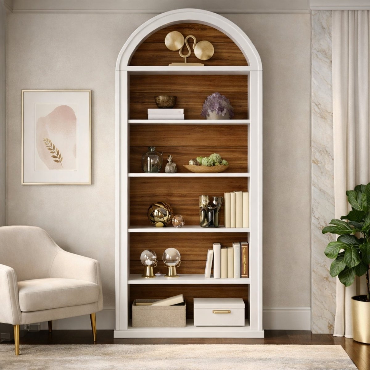 A single white and wood Kouvr Palladian arched bookcase styled with modern decor next to a cream-colored armchair, creating an elegant reading nook.