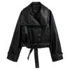 Model wearing the Kouvr Patricia women's cropped black faux leather trench jacket with a tie belt