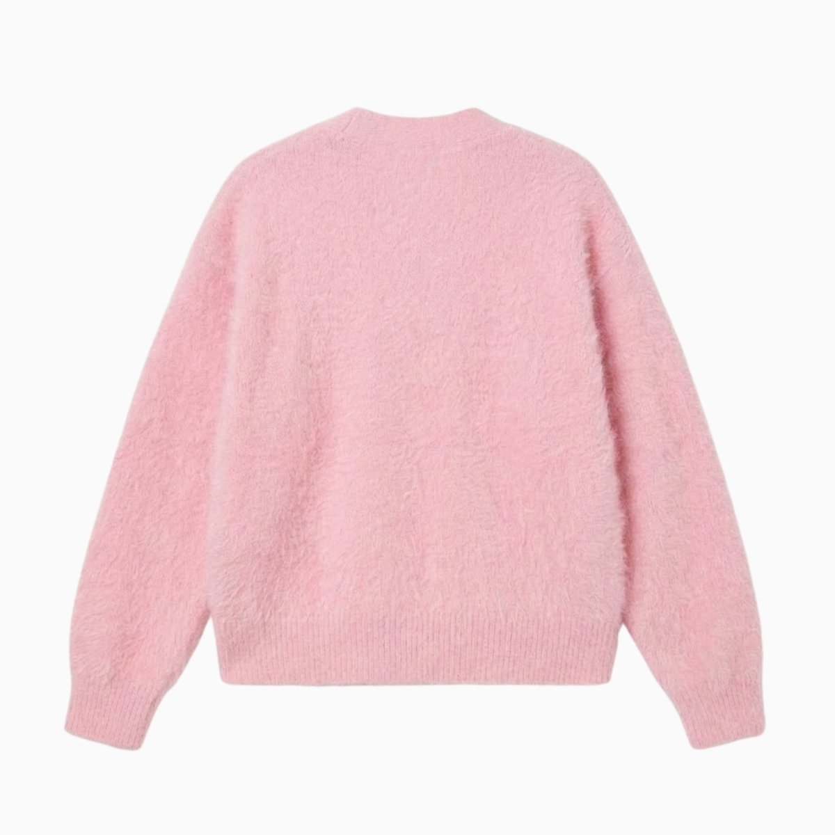 Flatlay of the back of the Kouvr soft pink mohair blend sweater showcasing its seamless construction.