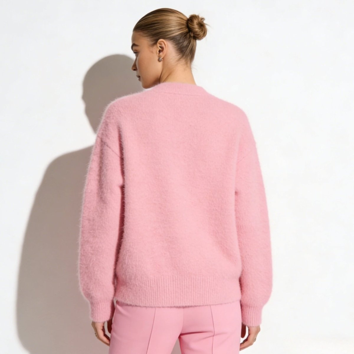 Back view of the Kouvr women's pink fluffy knit sweater highlighting the oversized silhouette.