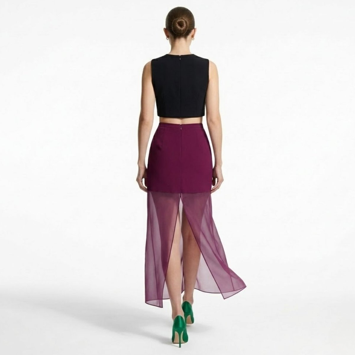 Back view of Kouvr plum sheer maxi skirt highlighting the invisible center back zipper and high sheer panel slit.