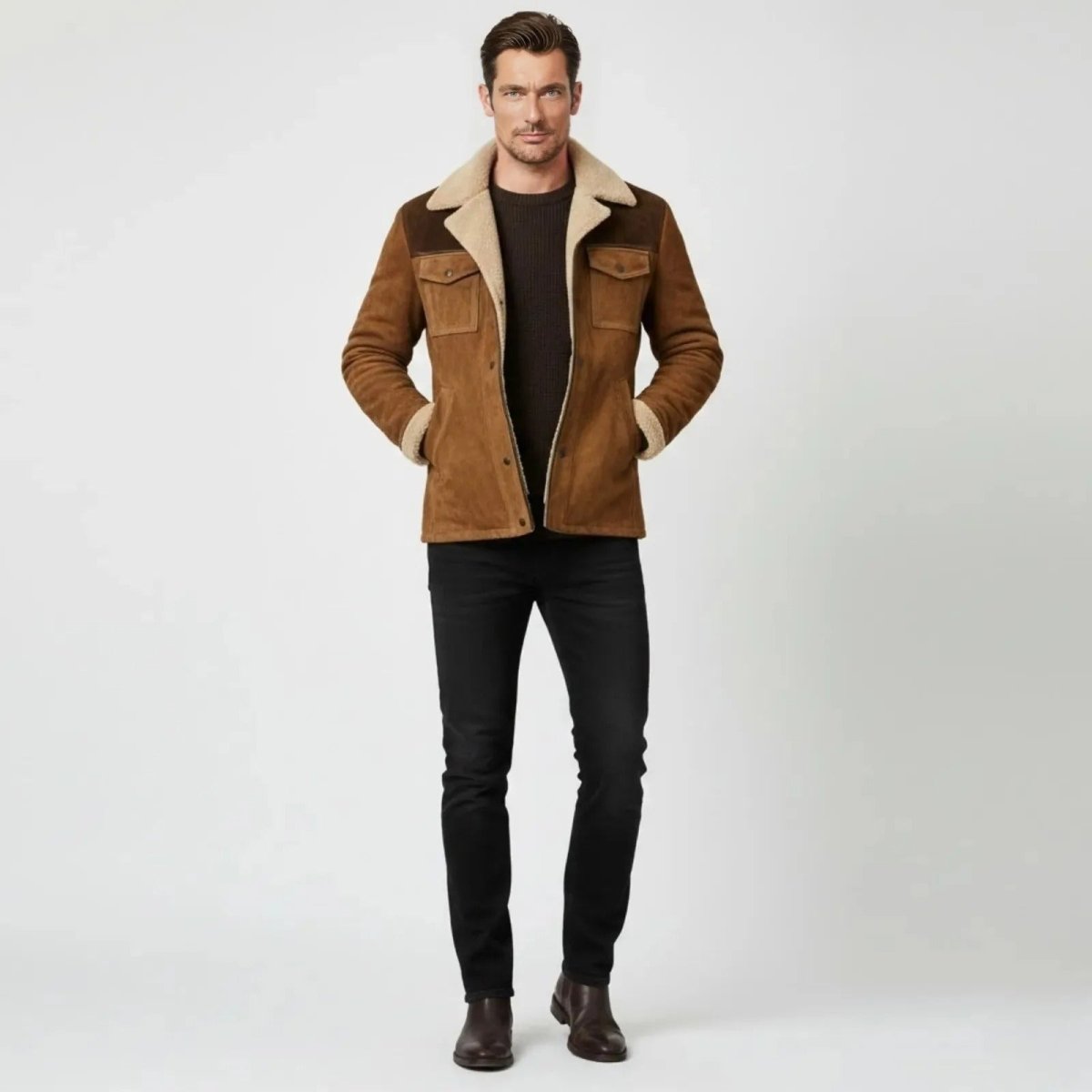 Model wearing the Kouvr Porter Suede Shearling Jacket in cognac brown with a dark sweater and black jeans.