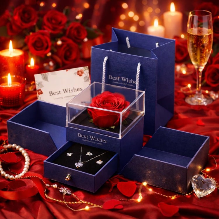 The Kouvr eternal rose jewelry gift box in royal blue, opened to show the preserved red rose and the hidden drawer with a silver crystal necklace and earrings set.