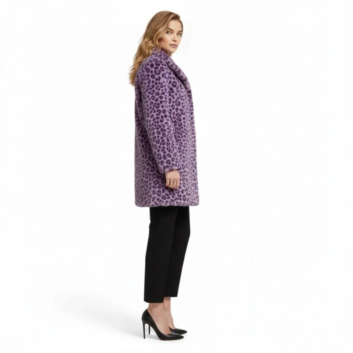 Model in a side profile view wearing the Kouvr purple leopard print faux fur coat to show its length and fit.