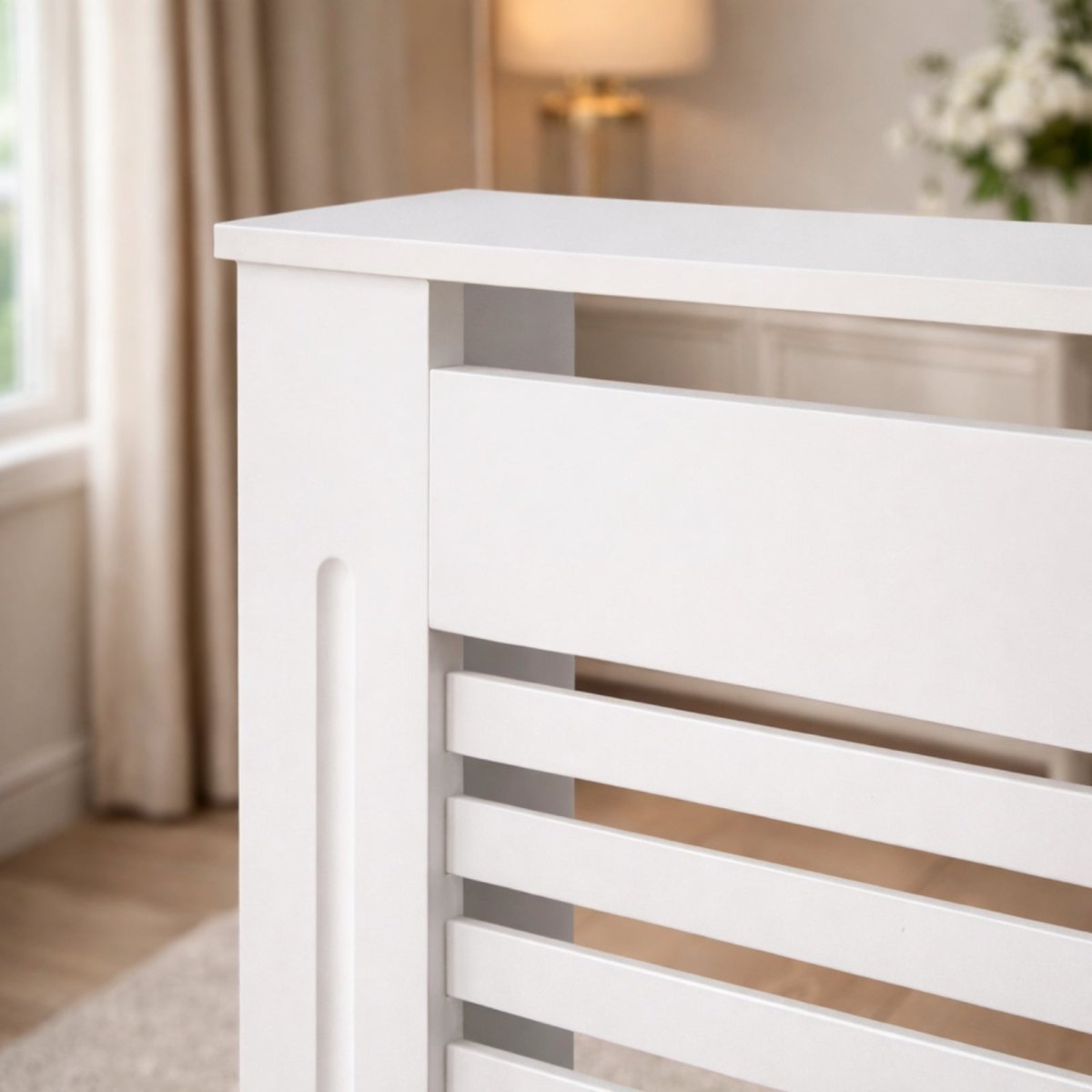 Detail shot showing the crisp corner and smooth satin white finish of the Kouvr radiator cover's top shelf and slatted front panel.
