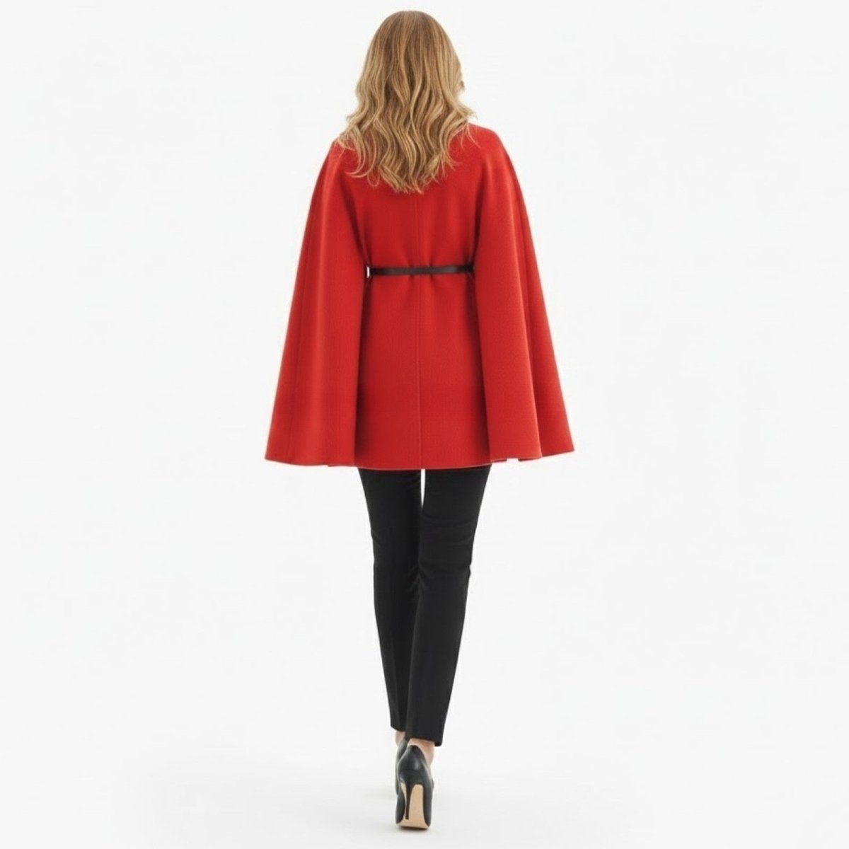 Back view of a female model in the Kouvr red belted cape coat, highlighting the clean lines and drape of the fabric.