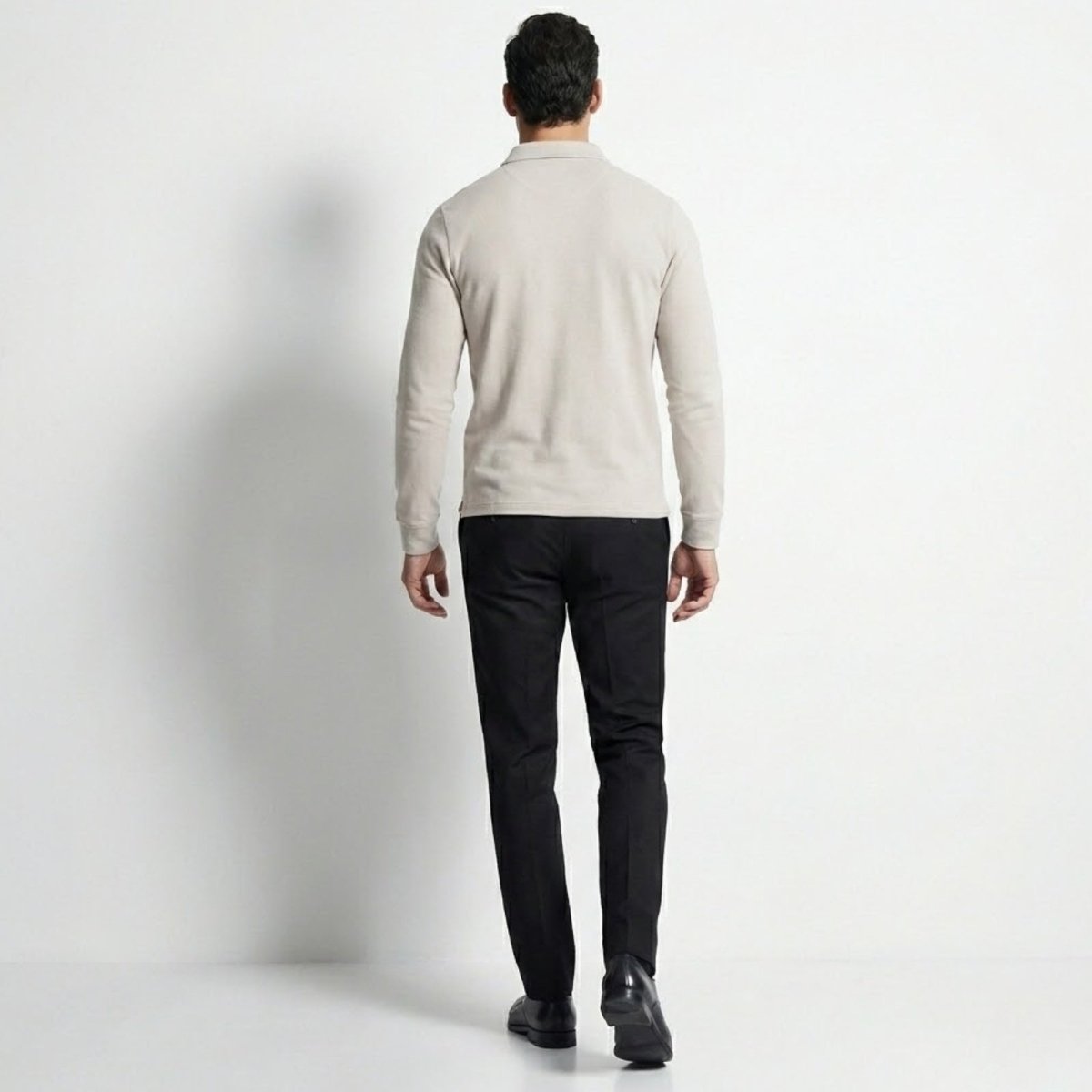 Back view of a man wearing the Kouvr cream long sleeve smart casual polo shirt.