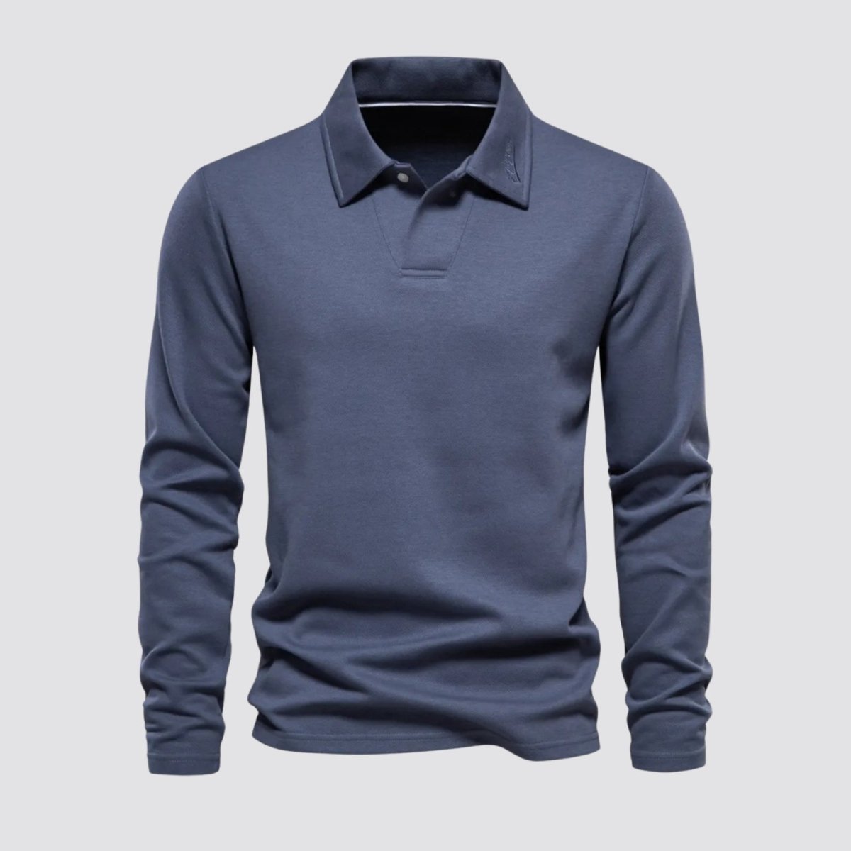 Front view of the Kouvr Rome Long Sleeve Polo in slate blue, laid flat to show the collar, placket, and fabric texture.