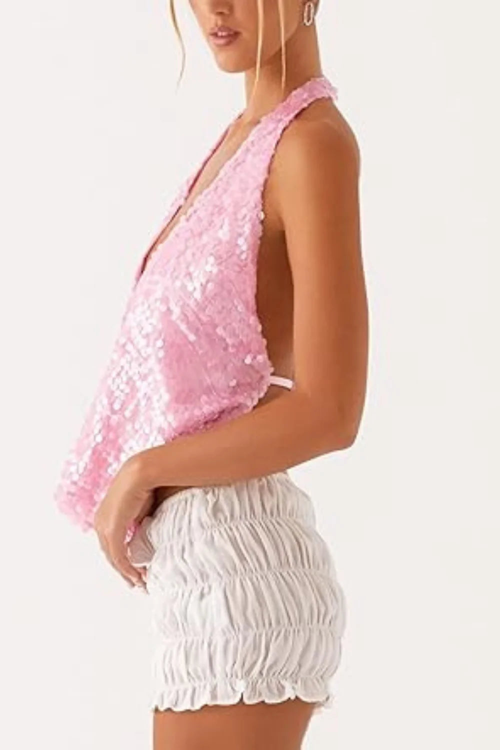 Model wearing Kouvr Fashion pink sequin backless cowl neck halter top with ruched shorts