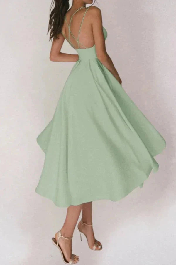 Model from behind showing the crisscross spaghetti straps on the Kouvr sage green A-line dress