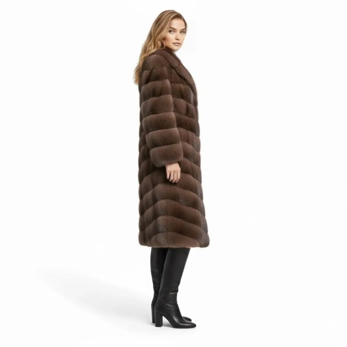 Side profile of a woman in the full-length brown vegan mink statement coat by Kouvr Fashion, highlighting its longline silhouette.