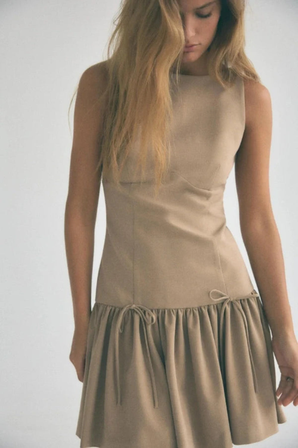 minimalist," "architectural," "modern," "fit and flare," "flounce hem," "day-to-night," and "structured fit