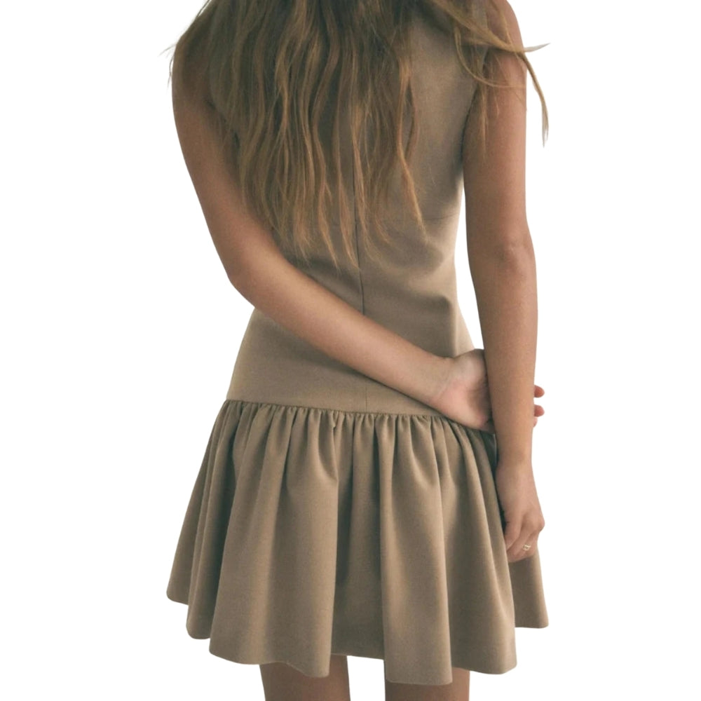 Woman wearing a khaki Kouvr dress on a white background