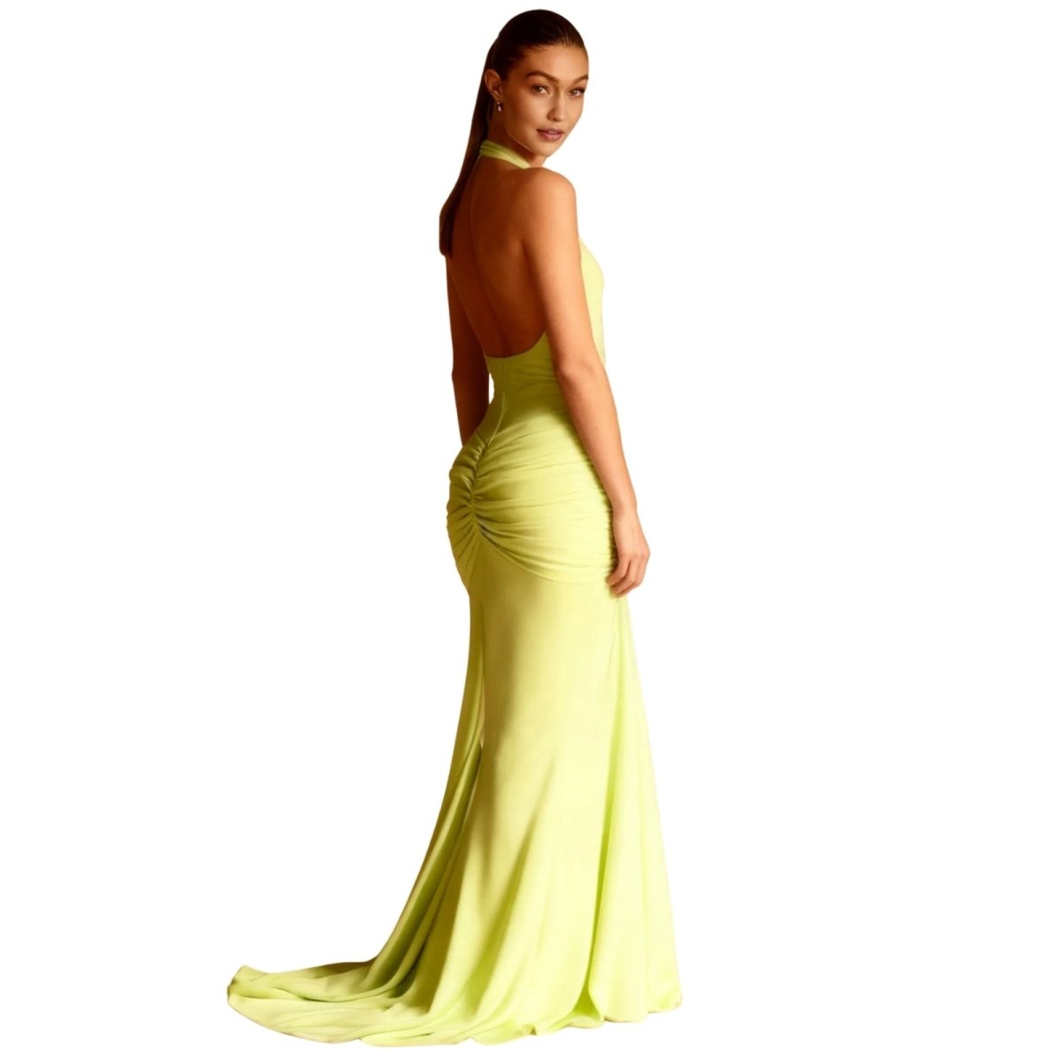 Woman wearing a light green Kouvr evening gown on a white background