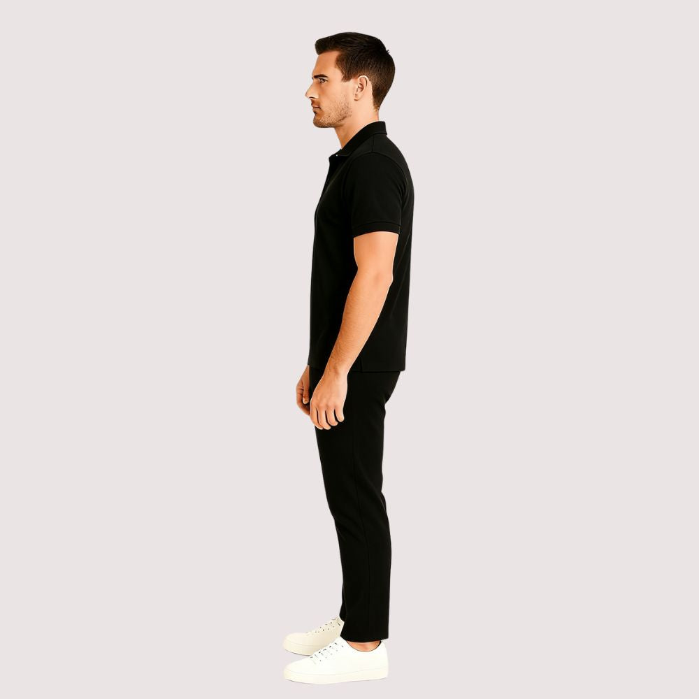 Man wearing the Kouvr Signature Black Polo Shirt with black trousers